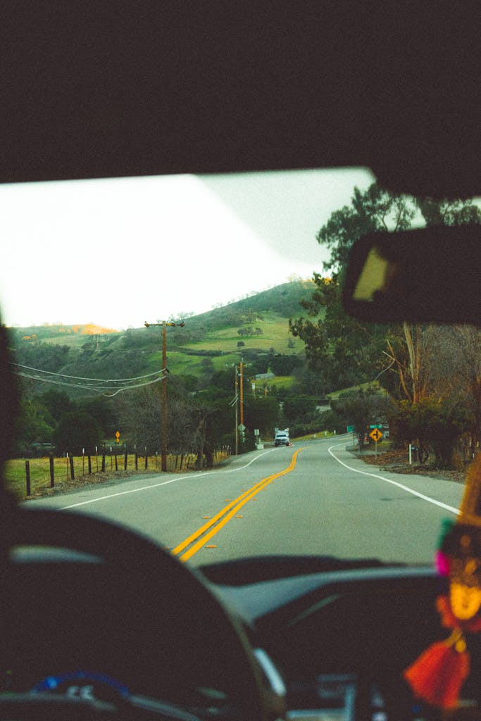 A view of a car driving down a road