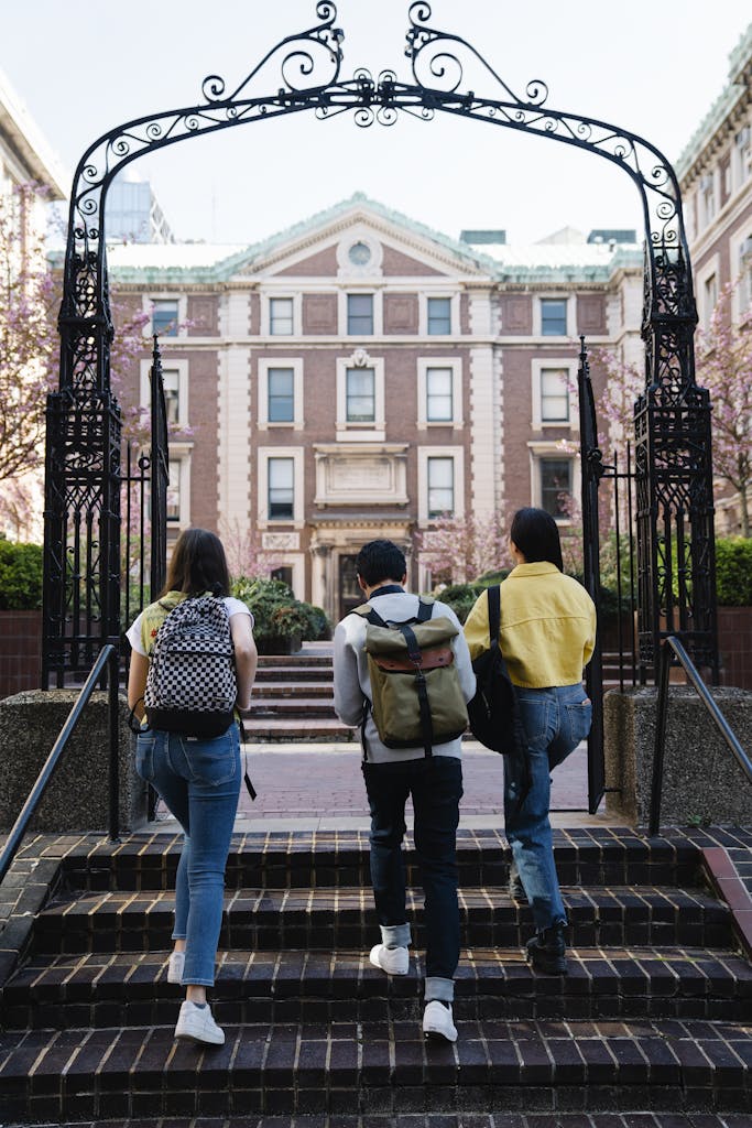 Back View of People Walking into a Campus